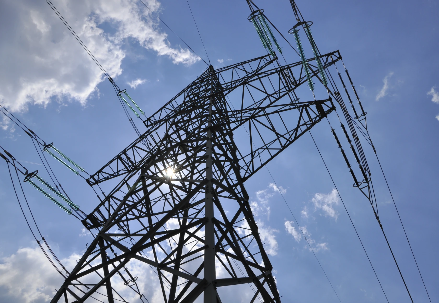 We are looking up at a power transmission tower.