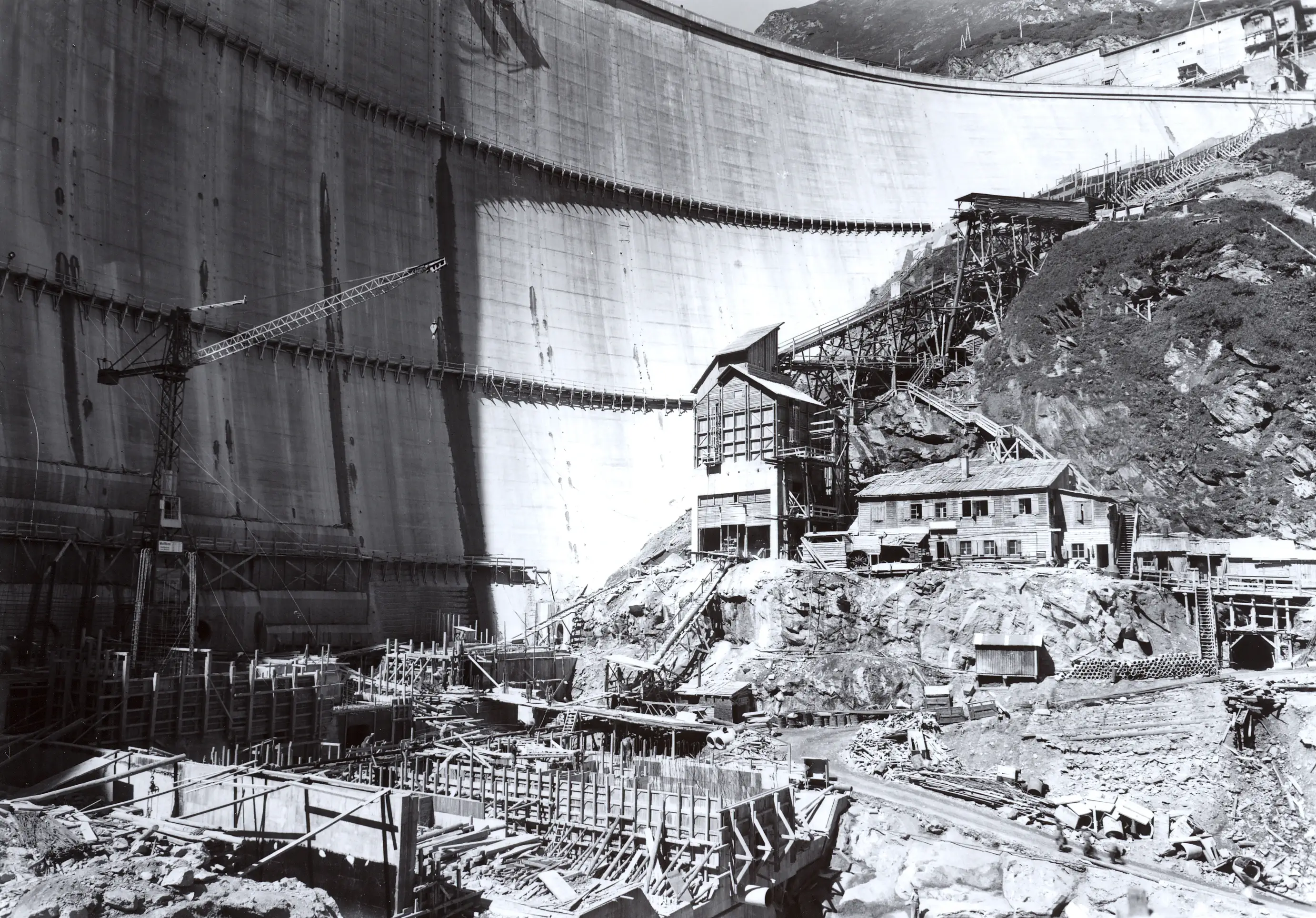 A black-and-white photo of a construction site at a dam.