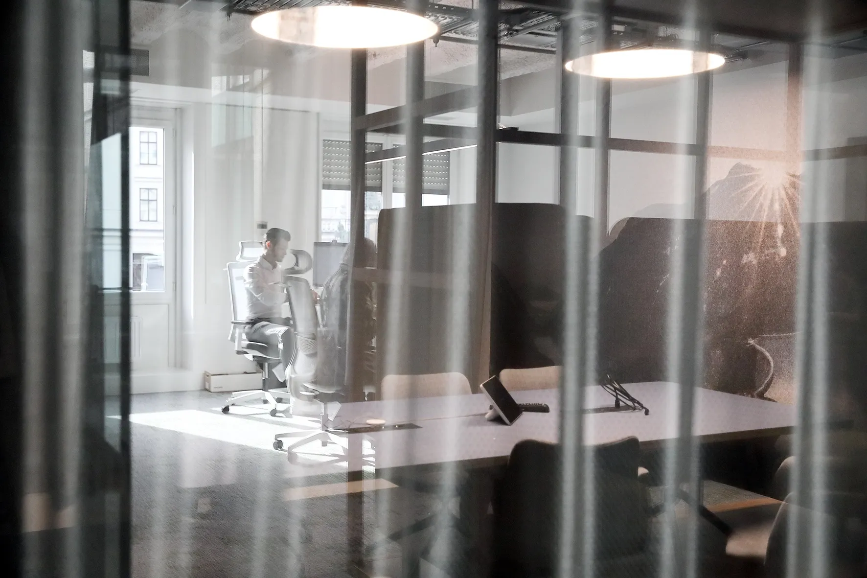 We are looking into a modern office where people are working.