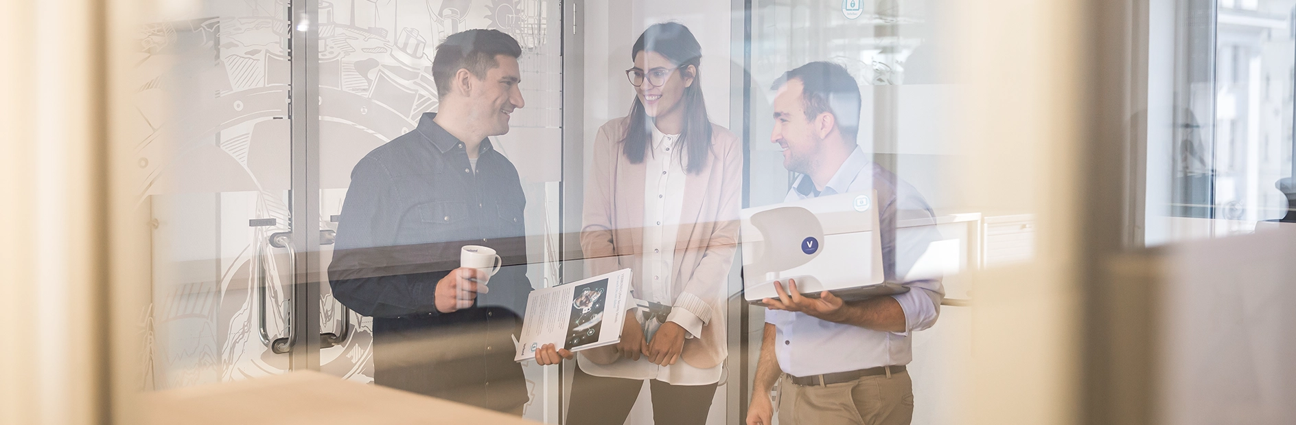 A group of three is happily engaged in conversation.
